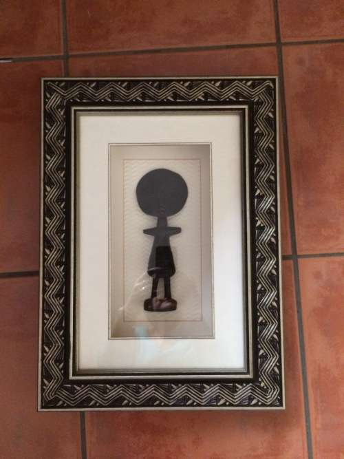 Framed wooden fertility goddess